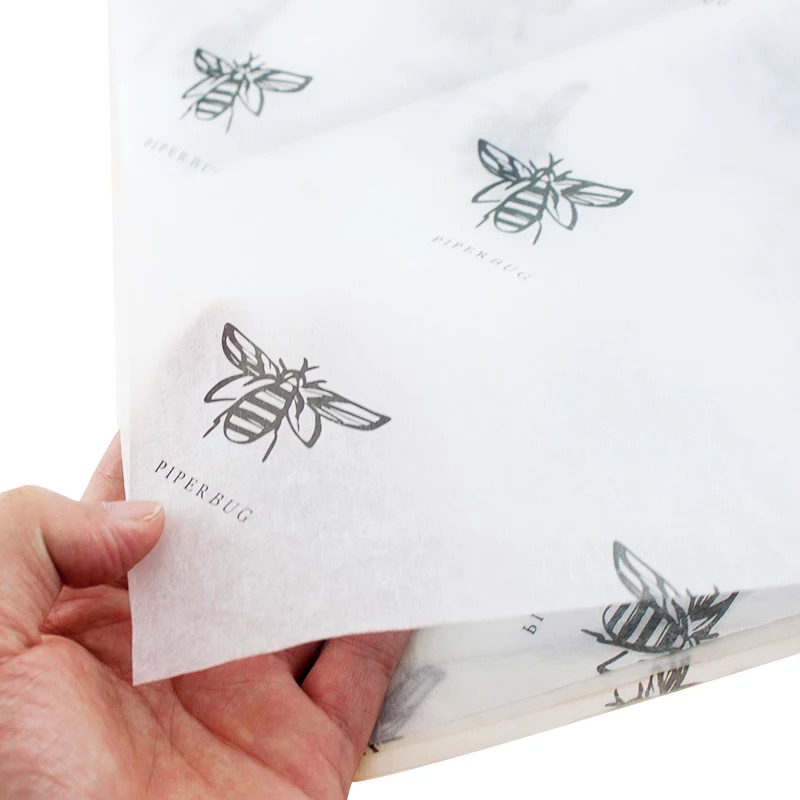 One-colour bee logo repeated across white custom printed tissue paper